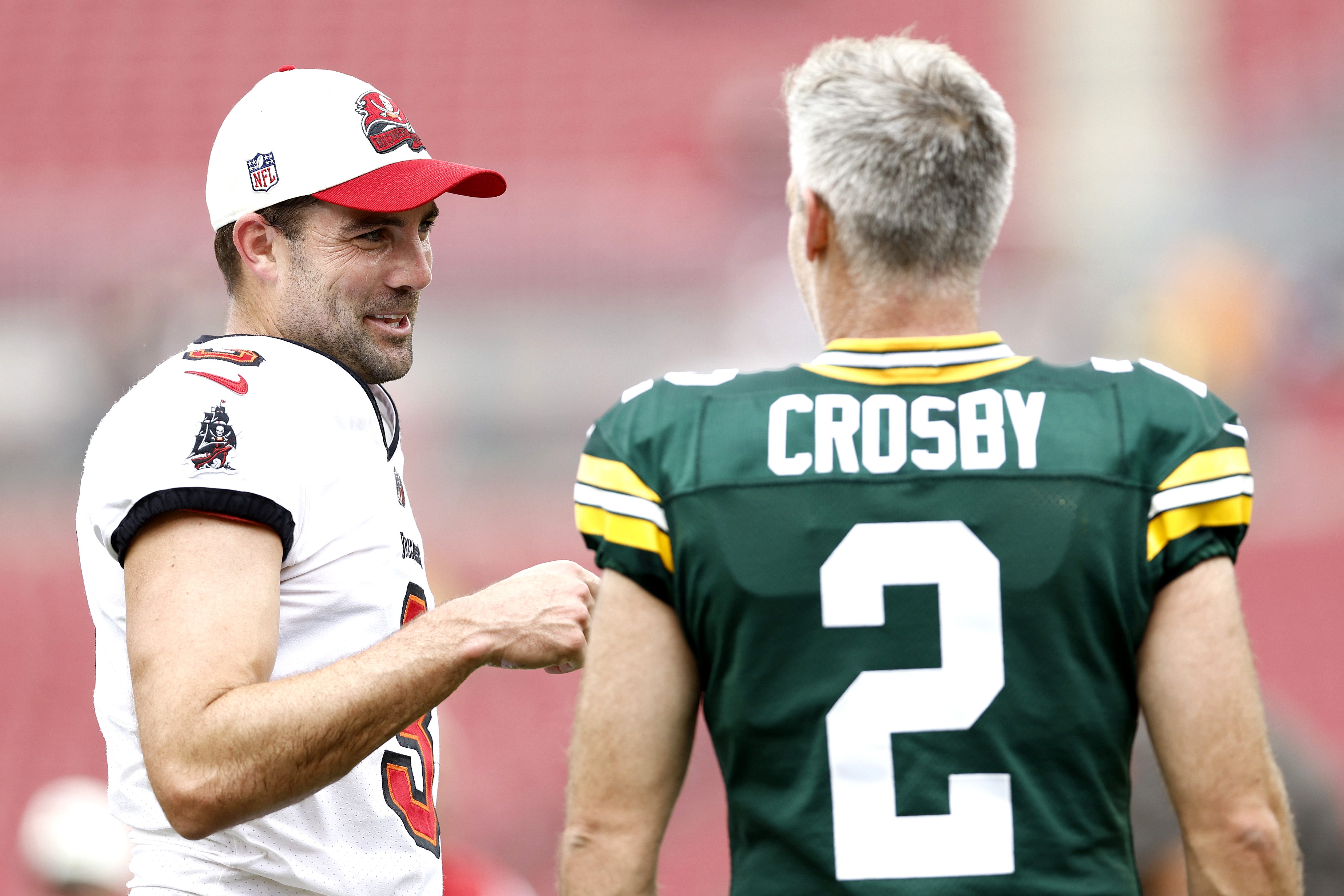 Ryan Succop (3) of the Tampa Bay Buccaneers talks with Mason Crosby (2) of the Green Bay Packers prior to the game on Sept. 25, 2022, at Raymond James Stadium in Tampa, Florida.