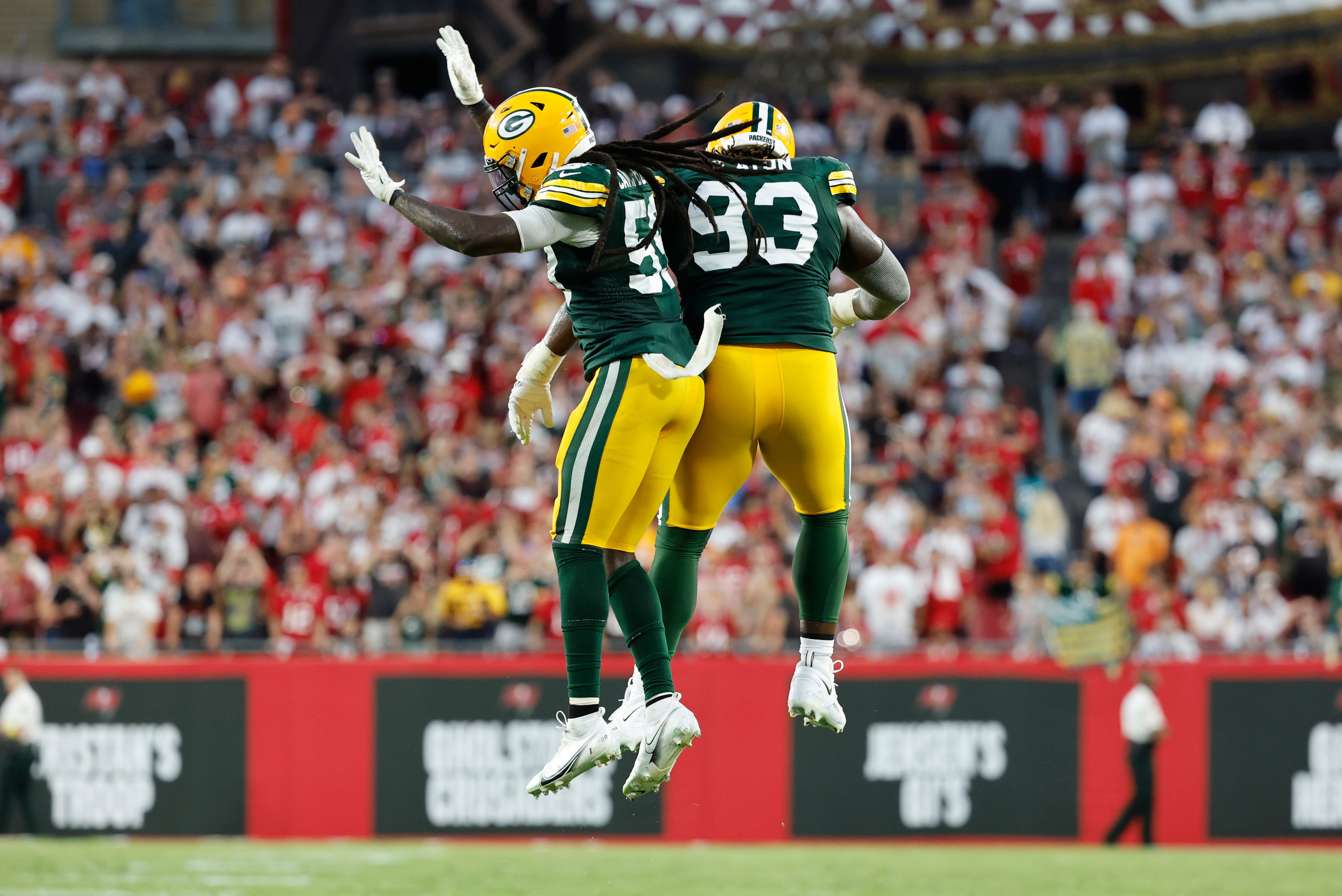Green Bay Packers linebacker De'Vondre Campbell (59) and defensive tackle T.J. Slaton (93) celebrate after the Tampa Bay Buccaneers miss the 2-point conversion against the Tampa Bay Buccaneers during the fourth quarter on Sept. 25, 2022, at Raymond James Stadium.