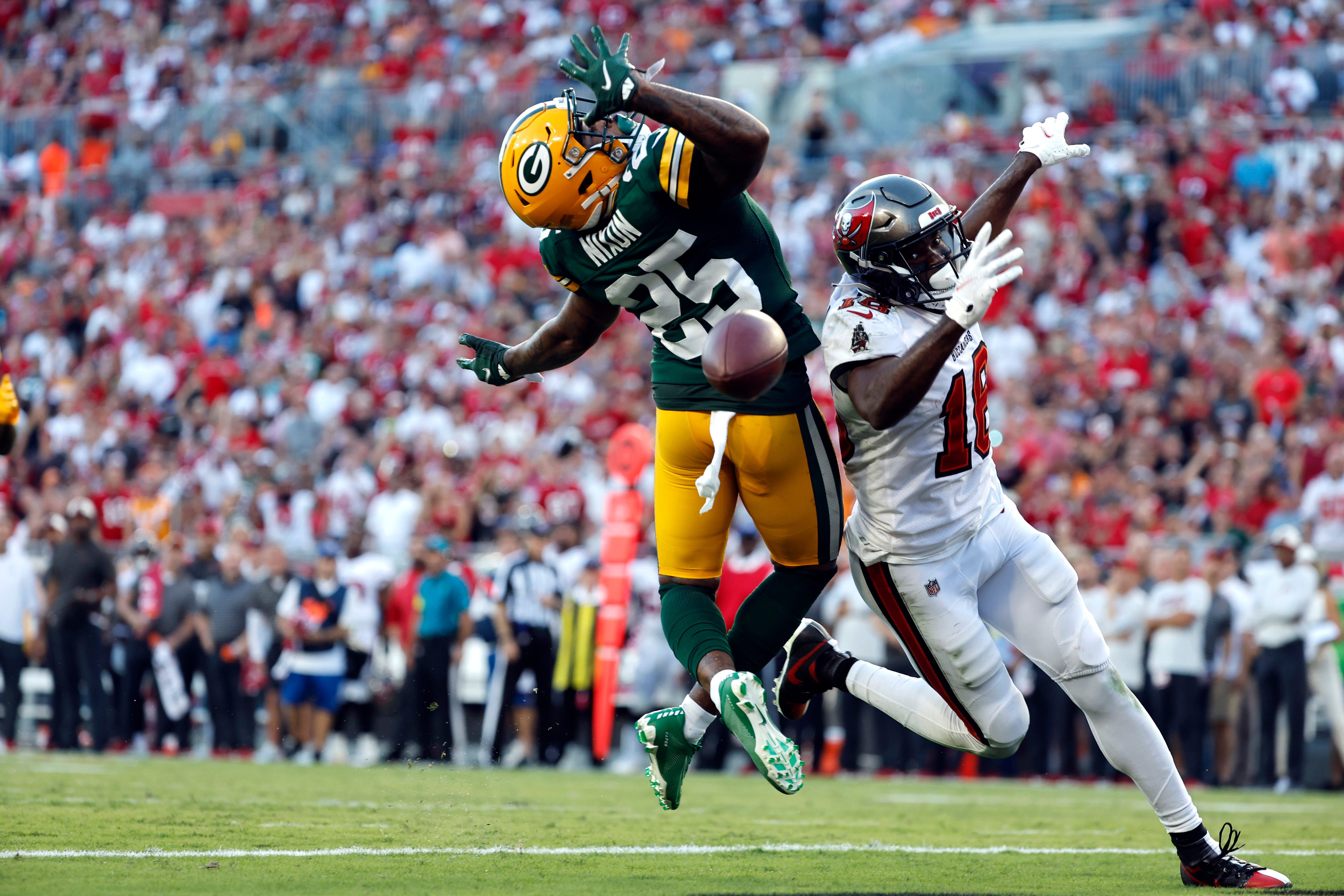 Green Bay Packers cornerback Keisean Nixon (25) breaks up a catch intended for Tampa Bay Buccaneers wide receiver Breshad Perriman during the second half on Sept. 25, 2022, at Raymond James Stadium in Tampa, Florida.